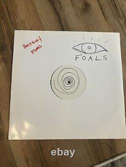 Vinyle Split LP de Foals dédicacé signé par Yannis avec le logo de l'œil dessiné à la main